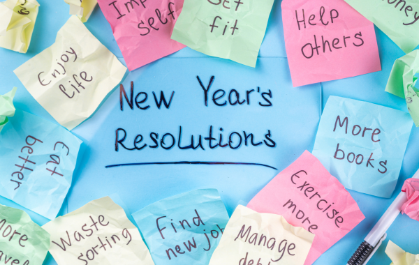 "New Year's Resolutions" is written in the center surrounded by a variety of various colored post it notes that feature people's resolutions
