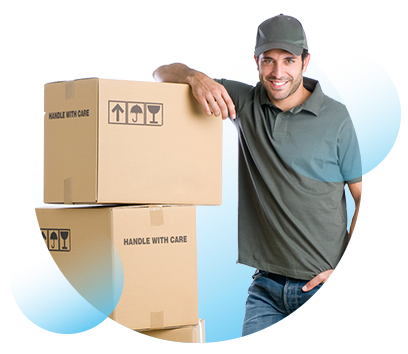 A man with a hat leans on a tall stack of cardboard boxes