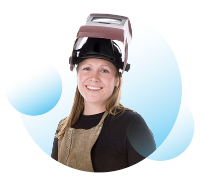 A woman wearing an apron and a face mask that is pushed up and is resting on the top of her head