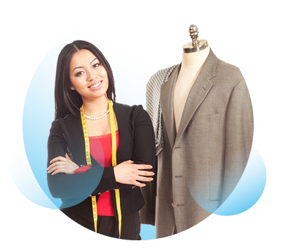 A woman with a measuring tape around her neck stands next to a mannequin which has an in process garment displayed on it