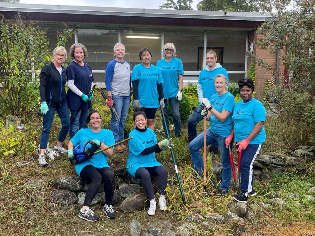Photo of Fidelity Bank employees who are participating in community work. They are posing for the photo and smiling